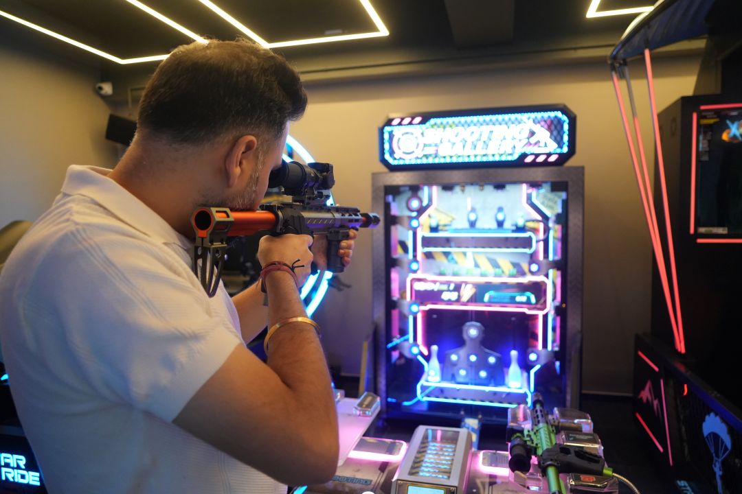 Two players competing in Shooting Gallery arcade game